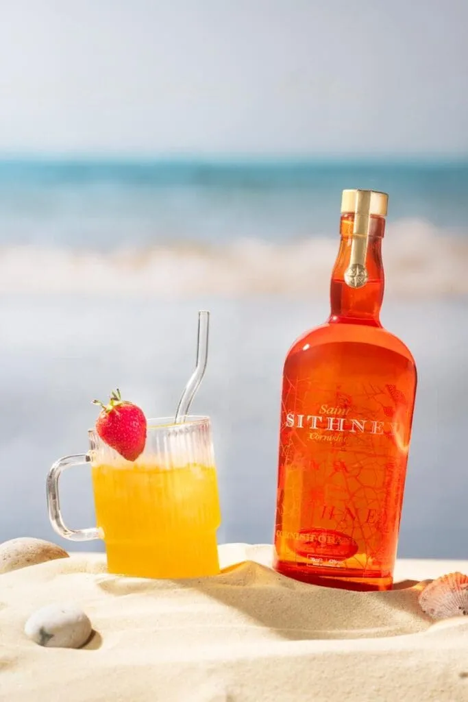 Sithney A Bottle Of Gin And A Glass On A Beach