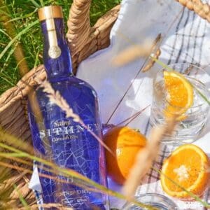 Sithney Bottle And Oranges In Basket In Field