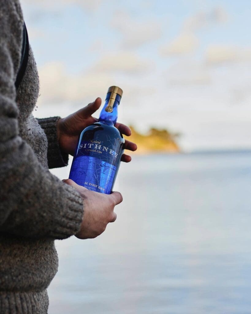 Sithney Bottle In Hand With Sea In Background