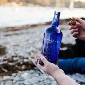 Sithney Man Opening Bottle On Beach
