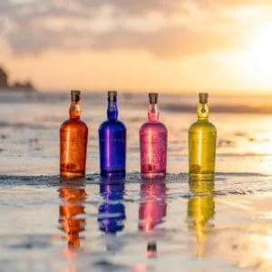 Saint Sithney Gin Bottles On Beach At Sunset
